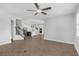 Open-concept living room flows into a modern kitchen with stainless steel appliances and center island at 32004 Redtail Reserve Blvd, Sorrento, FL 32776