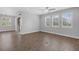 Bright living room with tile flooring and windows overlooking the landscaped backyard at 32004 Redtail Reserve Blvd, Sorrento, FL 32776