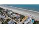 Expansive aerial view of a coastal home with direct beach access and beautiful ocean views at 3309 Hill St, New Smyrna Beach, FL 32169