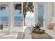 Close-up view from the bedroom balcony showing beach access, white railing, and palm trees at 3309 Hill St, New Smyrna Beach, FL 32169