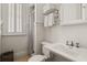 Bright bathroom featuring white cabinetry, a shower, and modern fixtures at 3309 Hill St, New Smyrna Beach, FL 32169