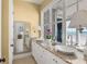 Luxurious bathroom featuring double sinks, granite countertops, and ocean views at 3309 Hill St, New Smyrna Beach, FL 32169
