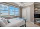 Cozy bedroom with serene ocean views, a ceiling fan, and built-in shelving at 3309 Hill St, New Smyrna Beach, FL 32169