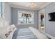 Relaxing bedroom featuring an ocean view, ceiling fan, and easy balcony access at 3309 Hill St, New Smyrna Beach, FL 32169