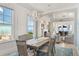 Bright dining room with decorative lighting adjacent to the living room with ocean views at 3309 Hill St, New Smyrna Beach, FL 32169