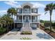 Gray two-story home with double balconies, a beach view, and a two-car garage at 3309 Hill St, New Smyrna Beach, FL 32169