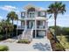 Beautiful multi-story coastal home with charming balconies and meticulous landscaping at 3309 Hill St, New Smyrna Beach, FL 32169