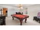 A spacious game room featuring a pool table, dining area, and stylish furnishings at 3309 Hill St, New Smyrna Beach, FL 32169