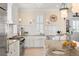 Classic kitchen with white cabinets, stainless appliances, granite counters, and subway tile backsplash at 3309 Hill St, New Smyrna Beach, FL 32169