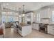 Open kitchen with stainless steel appliances and breakfast bar, flowing into a bright living area at 3309 Hill St, New Smyrna Beach, FL 32169