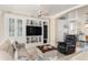 Spacious living room with custom built-ins, neutral walls, and a view into the kitchen at 3309 Hill St, New Smyrna Beach, FL 32169