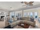 Spacious living room with cozy sectional, columns, and access to an ocean view at 3309 Hill St, New Smyrna Beach, FL 32169