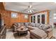 Comfortable living room with wood-paneled walls, ceiling fan, and a view into the wine storage at 3309 Hill St, New Smyrna Beach, FL 32169
