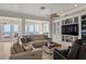 Bright living room with a view of the beach and white trim, leading to the kitchen at 3309 Hill St, New Smyrna Beach, FL 32169