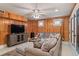 Cozy living room with wood-paneled walls, comfortable seating, and a mounted television at 3309 Hill St, New Smyrna Beach, FL 32169