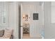 Charming powder room with beadboard walls, a decorative mirror, and a stylish vessel sink at 3309 Hill St, New Smyrna Beach, FL 32169