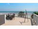 Rooftop deck featuring dining set and telescope, showcasing ocean views at 3309 Hill St, New Smyrna Beach, FL 32169