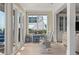 Bright sunroom featuring neutral tile floors, white trim, rocking chairs, and an ocean view at 3309 Hill St, New Smyrna Beach, FL 32169