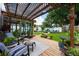 Backyard wooden deck with furniture, landscaping, and view of fire pit area at 415 Eastbridge Dr, Oviedo, FL 32765