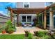 Backyard wooden deck under a pergola with seating and lush landscaping at 415 Eastbridge Dr, Oviedo, FL 32765