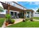Inviting backyard with a wooden pergola, deck and a charming sunroom at 415 Eastbridge Dr, Oviedo, FL 32765