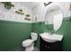 Stylish half bathroom featuring a green wainscoting, elegant wallpaper, and updated fixtures at 415 Eastbridge Dr, Oviedo, FL 32765