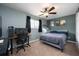 Bedroom featuring neutral colors, a ceiling fan, a large window, and a desk and computer setup at 415 Eastbridge Dr, Oviedo, FL 32765
