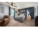 Comfortable bedroom featuring a ceiling fan, neutral colors, a cozy chair, and plenty of natural light at 415 Eastbridge Dr, Oviedo, FL 32765