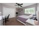 Bedroom with ample natural light, closet space, desk and tv setup, and a neutral color scheme at 415 Eastbridge Dr, Oviedo, FL 32765
