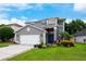 Charming two-story home with a manicured lawn and a freshly painted gray exterior at 415 Eastbridge Dr, Oviedo, FL 32765