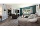 Cozy living room features large sectional couch, accent wall and modern decor at 415 Eastbridge Dr, Oviedo, FL 32765