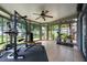 Sunroom with windows all around, weight lifting equipment, and adjacent garden views at 415 Eastbridge Dr, Oviedo, FL 32765