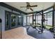 Bright sunroom featuring a ceiling fan, weight lifting equipment, and plenty of windows at 415 Eastbridge Dr, Oviedo, FL 32765