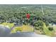 Serene aerial view of the property surrounded by lush greenery, lake, and waterfront at 419 Whitcomb Dr, Geneva, FL 32732