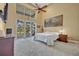Spacious bedroom with high ceilings, ceiling fan, a sliding glass door, and views of the backyard at 419 Whitcomb Dr, Geneva, FL 32732