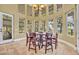 Bright breakfast nook featuring multiple large windows and a wooden table with six chairs at 419 Whitcomb Dr, Geneva, FL 32732