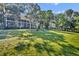 Expansive backyard view showcasing the spacious lawn and peaceful waterside of this home at 419 Whitcomb Dr, Geneva, FL 32732