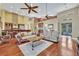 Cozy living room with hardwood floors, comfortable seating, and seamless connection to the kitchen area at 419 Whitcomb Dr, Geneva, FL 32732