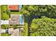 Aerial view showcasing the home with a pool, backyard, and nearby creek and treeline at 443 Magpie Ct, Poinciana, FL 34759