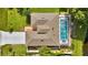 Aerial view showcasing the home, roof, swimming pool, driveway, backyard and partial surroundings at 443 Magpie Ct, Poinciana, FL 34759