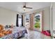 This bedroom has two windows with views of the yard and ceiling fan for added comfort at 443 Magpie Ct, Poinciana, FL 34759