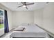 Cozy bedroom features a plush bed, a window with curtains, and a ceiling fan at 443 Magpie Ct, Poinciana, FL 34759