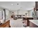 Bright and spacious living area with a grey leather sectional couch and direct view of the kitchen at 443 Magpie Ct, Poinciana, FL 34759