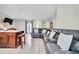 Spacious living room with an open layout and tile flooring with a grey leather sectional couch at 443 Magpie Ct, Poinciana, FL 34759