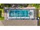 Aerial view of screened pool with clear water and yellow float at 443 Magpie Ct, Poinciana, FL 34759