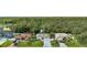 Street view of three homes with well-manicured lawns and mature landscaping at 443 Magpie Ct, Poinciana, FL 34759