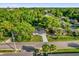 An aerial view of the front of the house with a large manicured front yard and mature trees at 461 Brentwood Dr, Daytona Beach, FL 32117