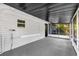 This is a large screened back porch with a white ceiling and gray floor at 461 Brentwood Dr, Daytona Beach, FL 32117