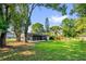 Lush backyard showcasing a well-maintained lawn and screened-in porch for outdoor enjoyment at 461 Brentwood Dr, Daytona Beach, FL 32117