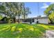 Spacious backyard with a green lawn and screened-in porch offering a peaceful outdoor retreat at 461 Brentwood Dr, Daytona Beach, FL 32117